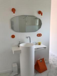 a bathroom with a white sink and a mirror at La Maison 1440 in L'Isle-sur-la-Sorgue