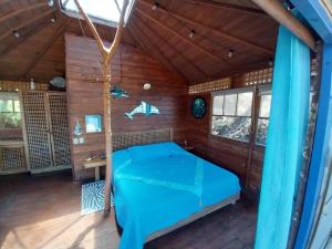 a bedroom in a house with a bed in it at Beached Bungalow Overlooking the Pacific Ocean in Boca Chica