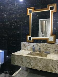 a bathroom with a sink and a mirror at Relais de Charme Boutique Hotel Pititinga in Rio do Fogo