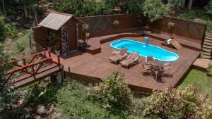 an overhead view of a wooden deck with a swimming pool at Cabanas dos Plátanos in Gramado