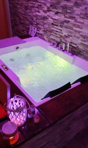 a jacuzzi tub in a room with purple lighting at COUNTRYSIDE SUITE in Ceprano