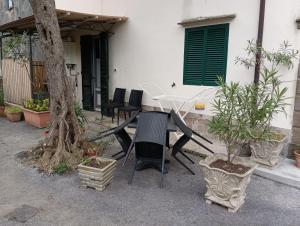 a table and chairs in front of a house at La casina fra gli olivi in Massarosa
