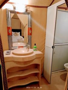 a bathroom with a sink and a mirror at Erg Chebbi Desert Luxury Camp in Merzouga