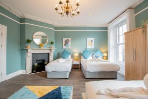a bedroom with two beds and a fireplace at The Yellow Door by Shortstays in Dublin