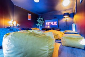 a bedroom with two beds with a netflix sign on the wall at The Yellow Door by Shortstays in Dublin
