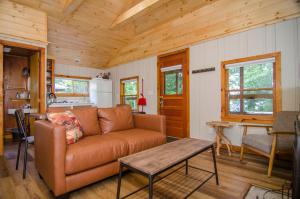 a living room with a couch and a table at Mountain Lake Cottages in Westmore