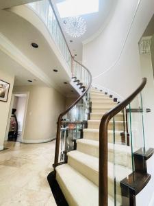 a spiral staircase in a house with a chandelier at SUMMER HOME in Vancouver