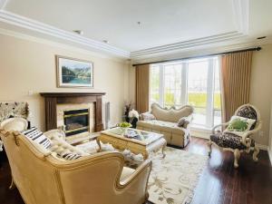 a living room filled with furniture and a fireplace at SUMMER HOME in Vancouver