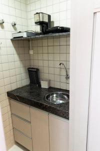 a kitchen counter with a sink in a room at 202 Flat Beira Mar Av Boa Viagem in Recife