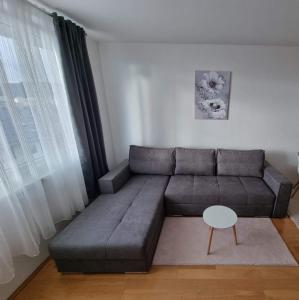 a living room with a couch and a table at Studio Apartman Maša Kupres in Kupres