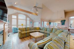 a large living room with couches and a table at Sand Goodies PI128 in Corolla