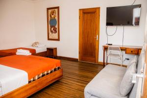 サンホセにあるHotel Luz de Lunaのベッド2台、薄型テレビが備わるホテルルームです。
