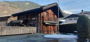 a large wooden house with snow on the ground at Chalet, Bagnes, Suisse in Le Châble