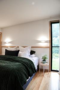 a bedroom with a large bed and a window at Riverstone in Porepunkah