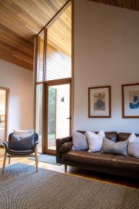 a living room with a couch and a chair at Riverstone in Porepunkah
