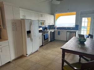 a kitchen with white cabinets and a table with a table sidx sidx sidx at The Mafolie Hotel in Mafolie +74 photos