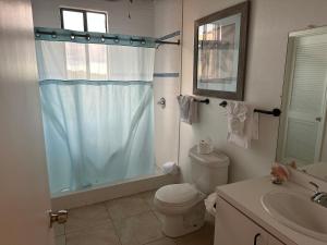 a bathroom with a shower and a toilet and a sink at The Mafolie Hotel in Mafolie