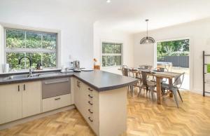 a kitchen with a table and a dining room at Karoo House in Greytown