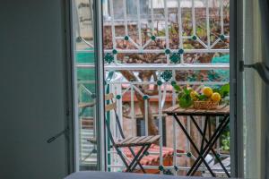 a table with a basket of fruit on a balcony at La Dimora di Nonna Maria in Maiori