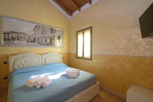 a bedroom with a bed with two towels on it at Appartamenti S Onofrio Rho in Rho