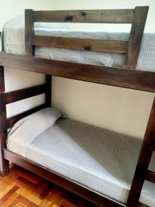two bunk beds in a room with wooden floors at Dpto dos dormitorios en Nueva Córdoba in Cordoba