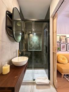 a bathroom with a sink and a shower at Estoril Tiny Home 5 Minutes From the Beach in Estoril