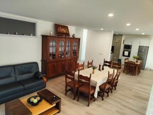 a living room with a table and chairs and a couch at Quinta de Basto House in Felgueiras