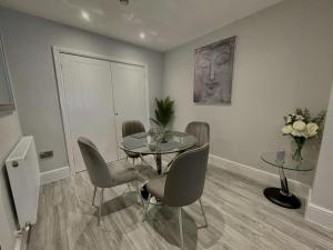 a dining room with a table and chairs at LYMM LIVING in Warrington