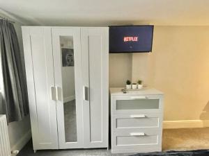a white cabinet with a tv on top of it at LYMM LIVING in Warrington