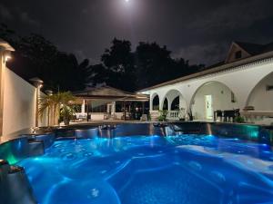 a hot tub in a backyard at night at Ma Chambre d’Hôte in Rémiré