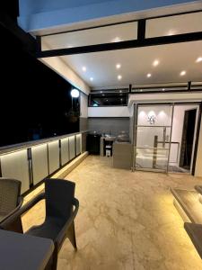 a view of a room with a table and chairs at Duplex con jacuzzi y terraza privada in Santa Fe de Antioquia