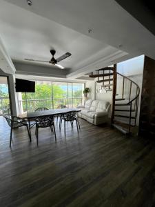 a living room with a couch and a table and chairs at Duplex con jacuzzi y terraza privada in Santa Fe de Antioquia