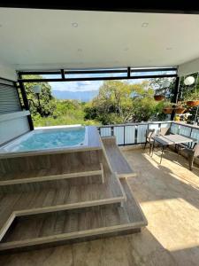 a hot tub on the deck of a house at Duplex con jacuzzi y terraza privada in Santa Fe de Antioquia +8 photos