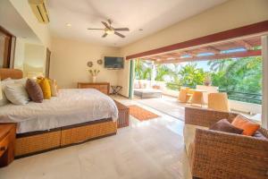 a bedroom with a bed and a living room at Vallarta Gardens V4 -Alberca y Roof Garden Private in Cruz de Huanacaxtle +68 photos