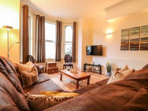 a living room with a couch and a table at Clover Court in Great Yarmouth