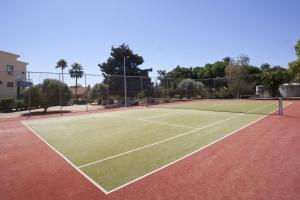 a tennis court with a net on top of it at Makronisos Village in Ayia Napa