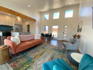a living room with a couch and a kitchen at Timber & Tin D 2Bed 2Bath w Pool & Rooftop Deck in Kanab