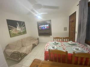 a living room with a table and a couch at Pé na Areia in Porto Seguro