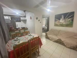 a room with a bed and a table in it at Pé na Areia in Porto Seguro