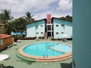 a large swimming pool in front of a building at Pé na Areia in Porto Seguro