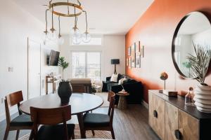 a living room with a table and a mirror at Gallery Retreat - Skyline Views - Zuni Lofts in Denver