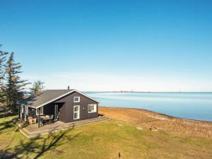 a tiny house on the shore of a lake at Two-Bedroom Holiday home in Harboøre 4 in Harboør