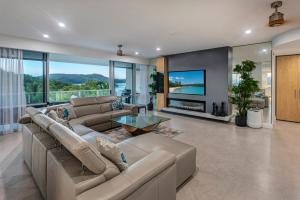 a large living room with a couch and a table at Allure on Hamilton Island by HIHA in Hamilton Island