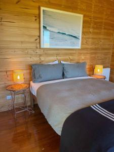a bedroom with a large bed with two lamps on tables at Pt Hesse Luxury Coastal Homestead in Port Campbell