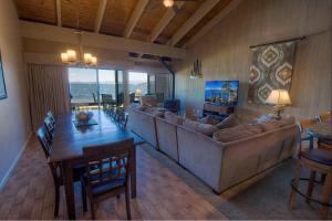 a living room with a large couch and a table and chairs at Sky Lake Splendor condo in South Lake Tahoe