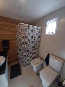 a bathroom with a toilet and a sink and a window at Dpto Turístico Renato Mendoza in Mendoza