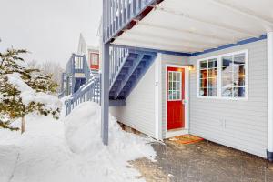 a house with a red door in the snow at Riverbend in Newry