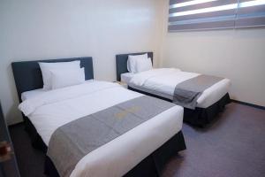 Letto o letti in una camera di Cube9 Resort & Spa 큐브9 리조트 & 스파