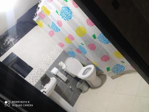 a bathroom with a toilet and a shower curtain at Hotel La coline in Beni Mellal