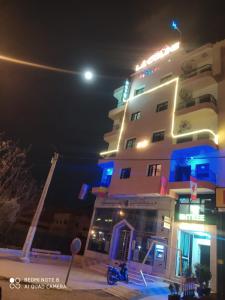 a hotel at night with the moon in the background at Hotel La coline in Beni Mellal